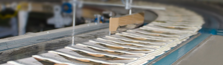 Newspapers on an assembly line.
