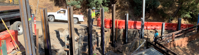 Construction workers work to build a retaining wall.