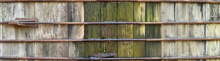 A closeup view of a water tank made of wood slats.