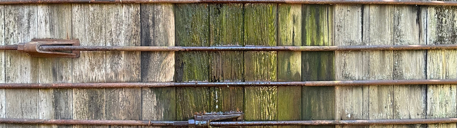 A closeup view of a water tank made of wood slats.